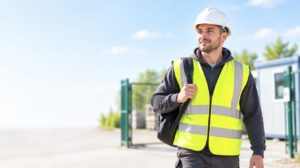 New construction operative arriving on site with a green Labourer CSCS card