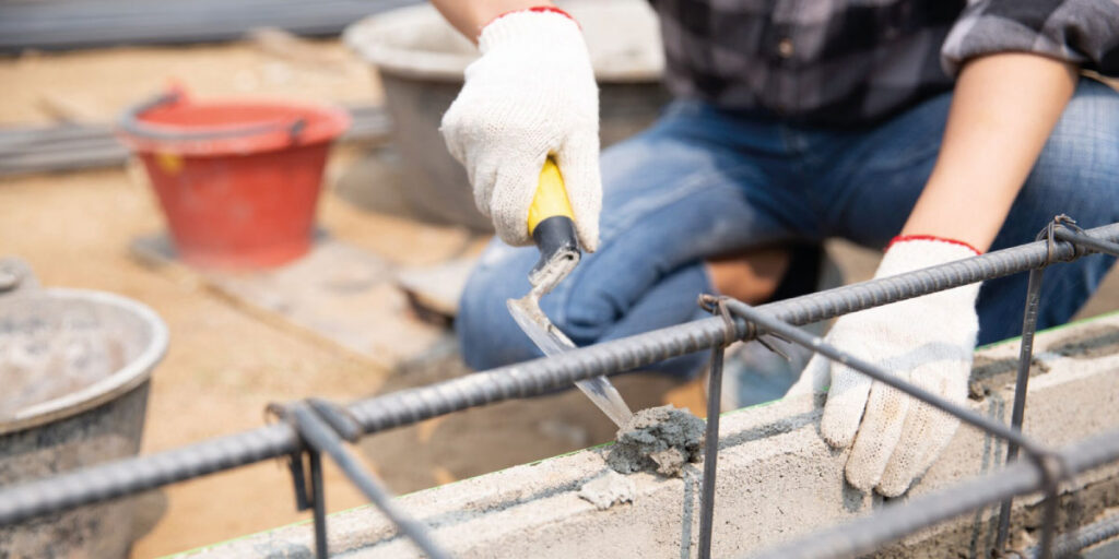 Photo of a worker building a wall