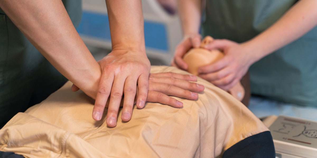 Photo of workers learning CPR on a CPR dummy