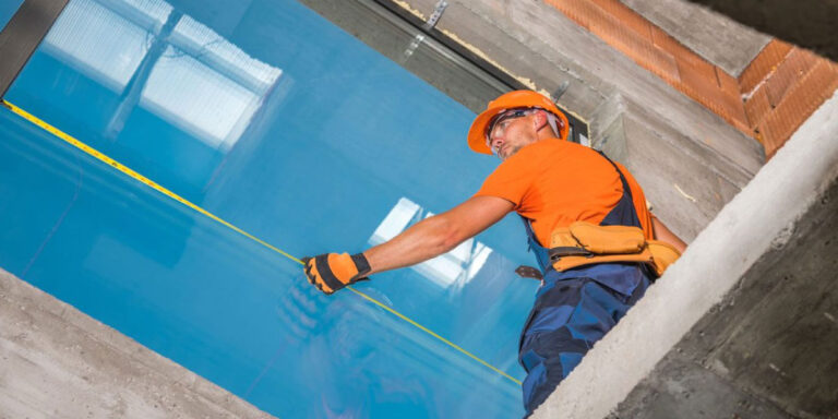 Photo of a construction worker installing glass