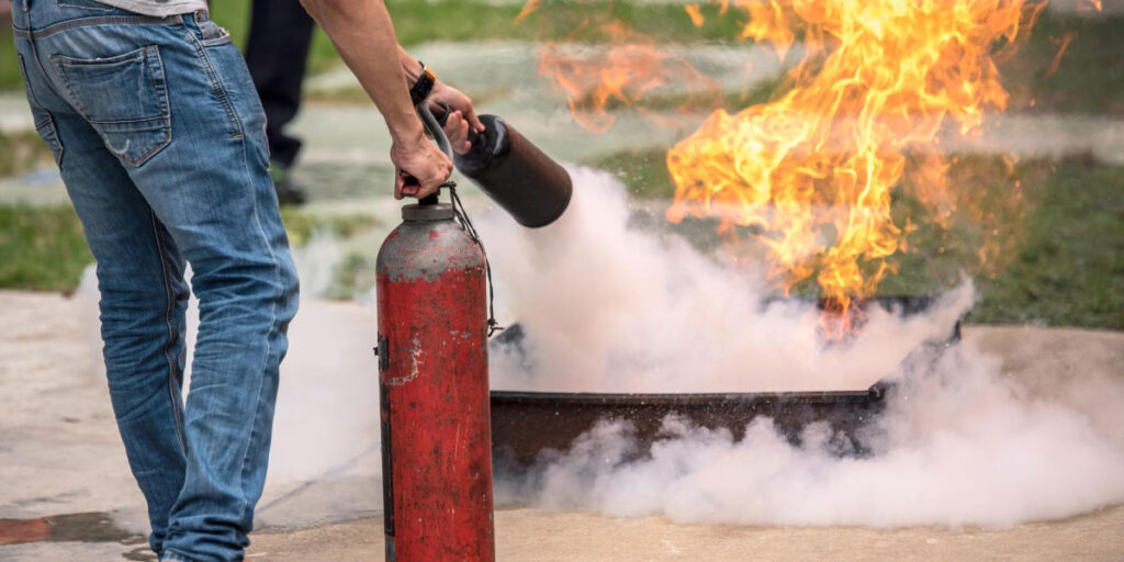 Photo of a worker putting out a fire