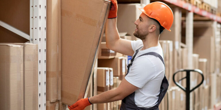 Photo of a worker carrying a box