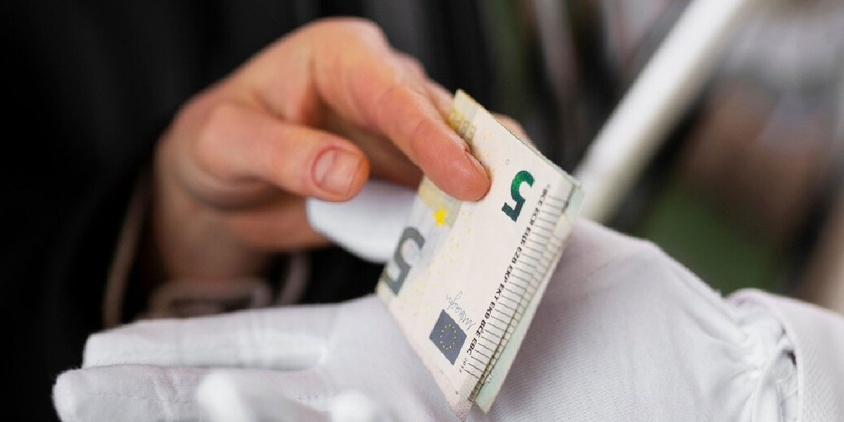 Photo of a person holding a bank note