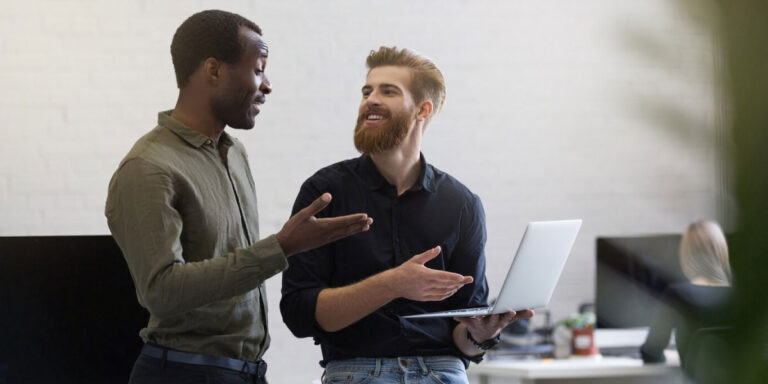 Photo of two workers having a discussion in the office