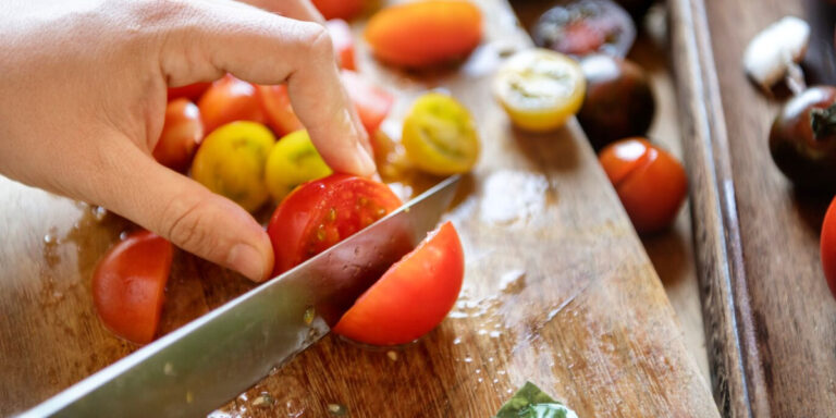 Photo of someone cutting a tomato