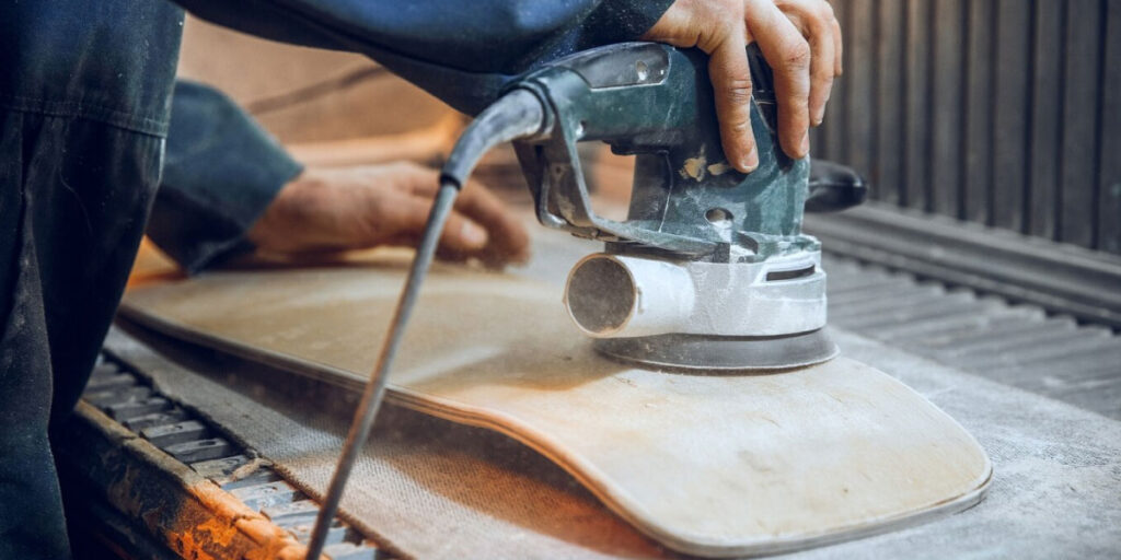 Photo of a worker using a sanding machine