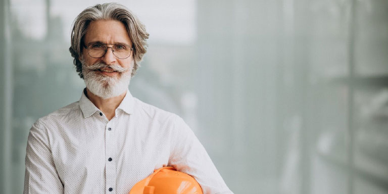 Photo of a man holding a hard hat under his arm