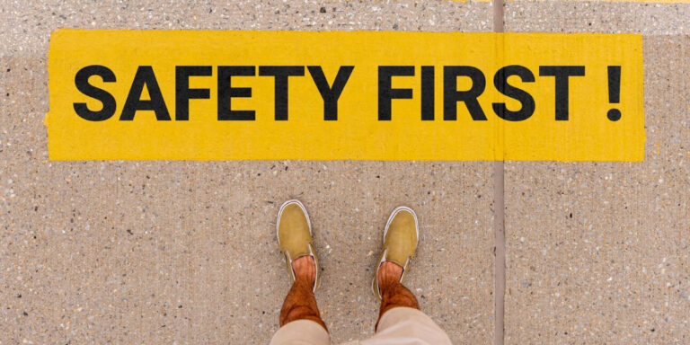 Photo of a man stood in front of a safety sign painted on the floor