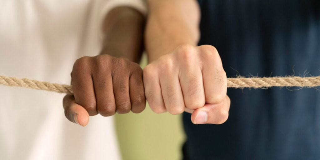 Photo of two people holding a rope