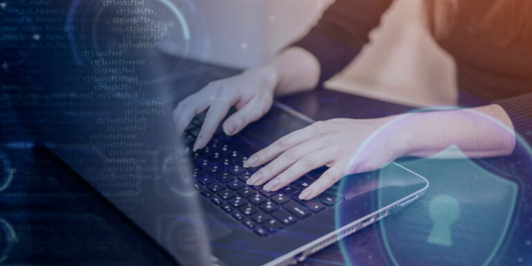 Photo of a woman typing on a laptop