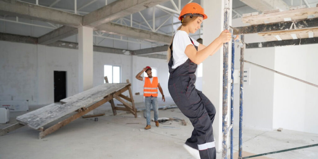 Photo of a construction worker climbing down a ladder safely